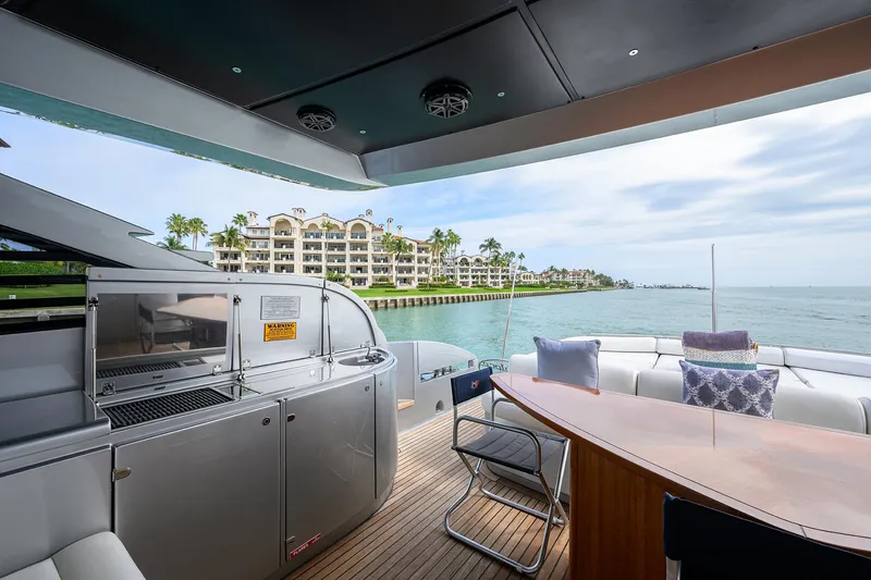 Slide: The Image of 2009 Pershing 90 Express yacht deck with waterfront view and luxury seating. - 40