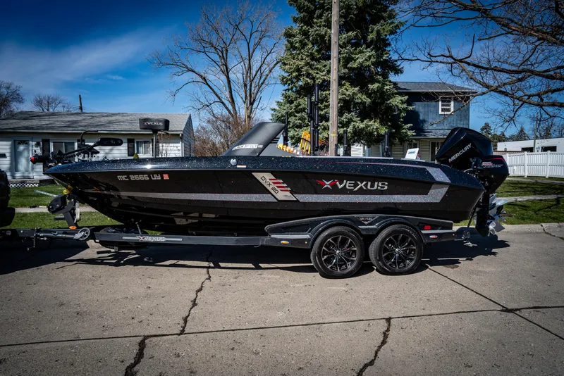 Slide: The Image of 2022 Vexus DVX20 boat on trailer, parked in residential area. - 10