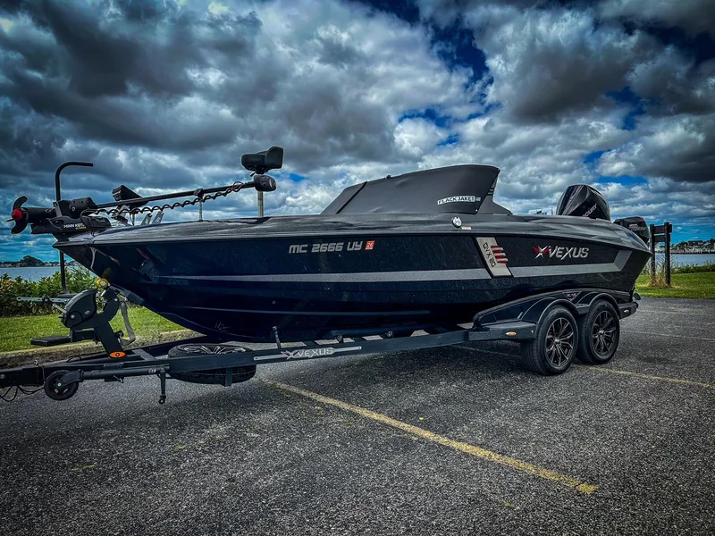Slide: The Image of 2022 Vexus DVX20 boat on a trailer under a cloudy sky. - 11
