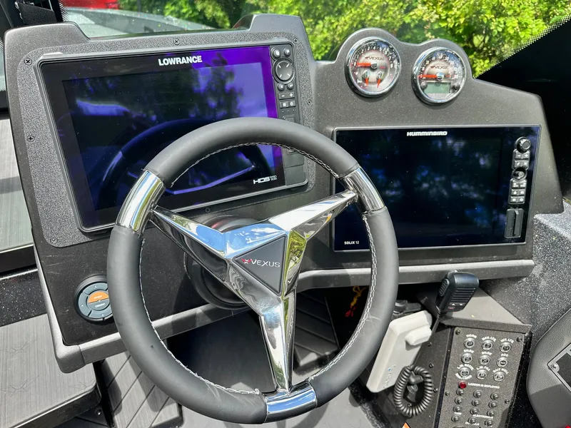 Slide: The Image of 2022 Vexus DVX20 boat dashboard with Lowrance and Humminbird displays. - 12