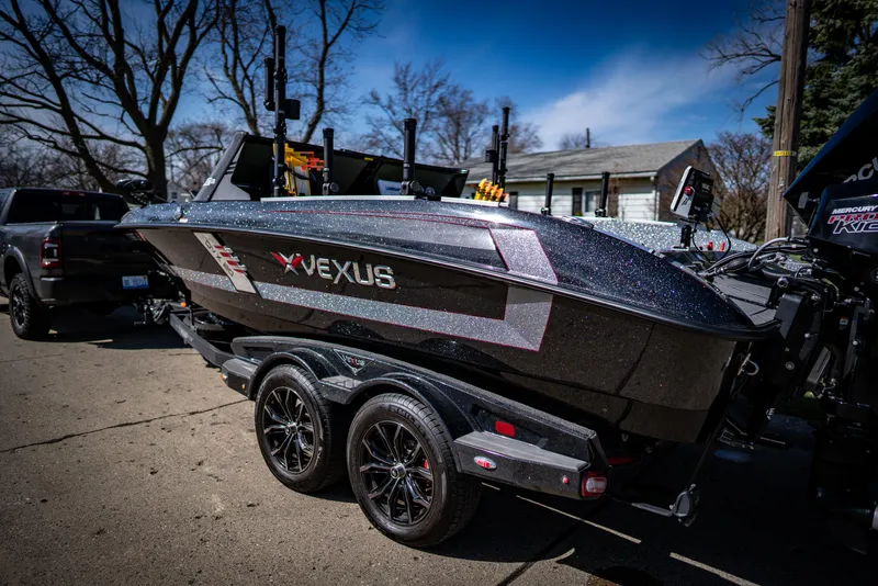 Slide: The Image of 2022 Vexus DVX20 boat on a trailer in a driveway. - 2