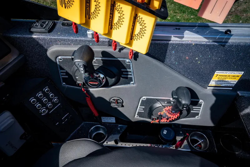 Slide: The Image of Control panel of a 2022 Vexus DVX20 boat with throttle and switches. - 7