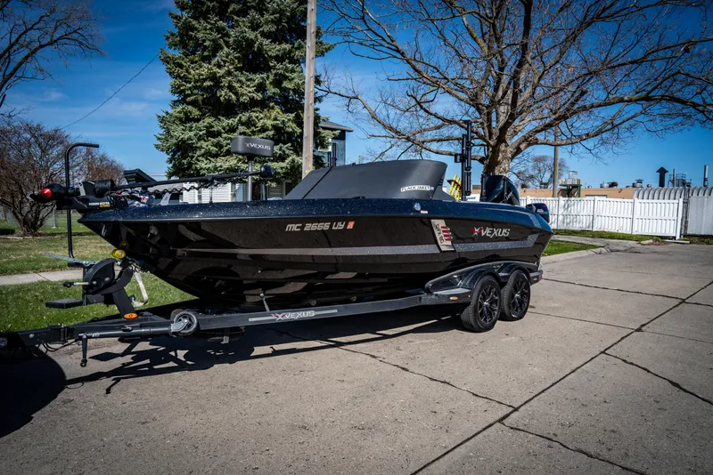 Slide: The Image of 2022 Vexus DVX20 boat on a trailer in a suburban driveway. - 9