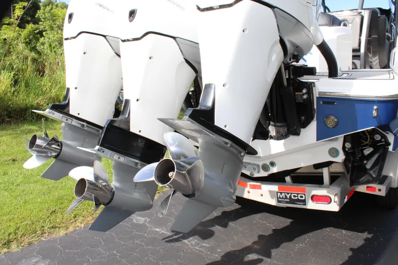 Slide: The Image of 2019 Nor-Tech 340 Sport Center Console boat engines and propellers on trailer. - 18
