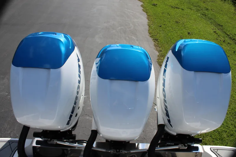 Slide: The Image of Three Mercury outboard engines on a 2019 Nor-Tech 340 Sport Center Console boat. - 22