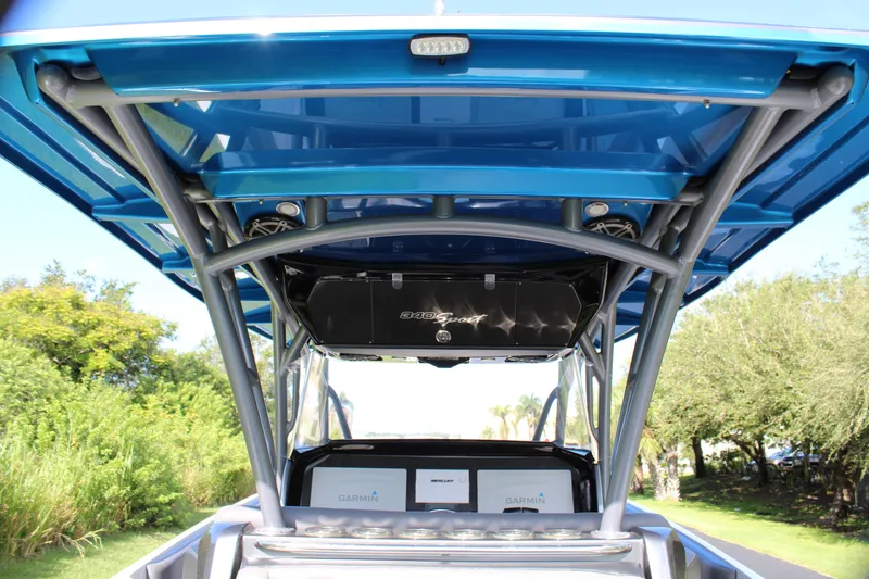 Slide: The Image of 2019 Nor-Tech 340 Sport Center Console boat with blue canopy and sleek design. - 28