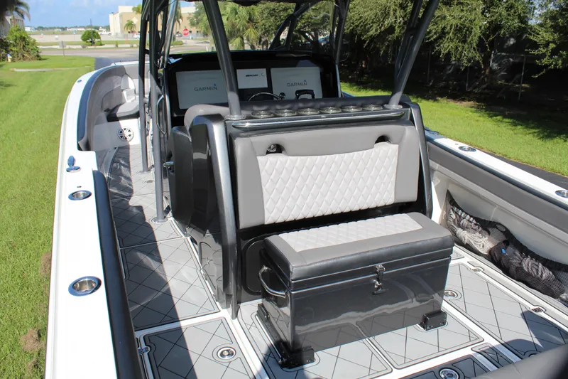 Slide: The Image of 2019 Nor-Tech 340 Sport Center Console interior with seating and storage. - 32