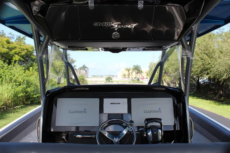 Slide: The Image of 2019 Nor-Tech 340 Sport Center Console dashboard with Garmin displays and steering wheel. - 33