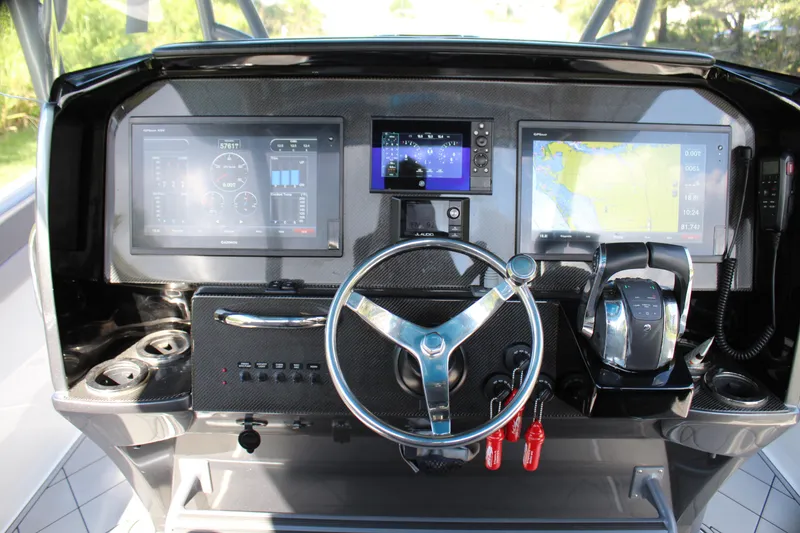 Slide: The Image of 2019 Nor-Tech 340 Sport Center Console dashboard with advanced navigation and control systems. - 37