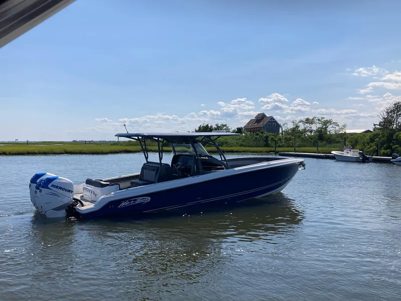 Slide: The Image of 2019 Nor-Tech 340 Sport Center Console boat on calm water. - 60