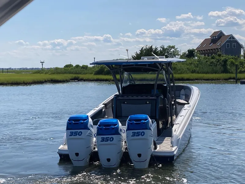 Slide: The Image of 2019 Nor-Tech 340 Sport Center Console boat with triple 350 engines on water. - 61