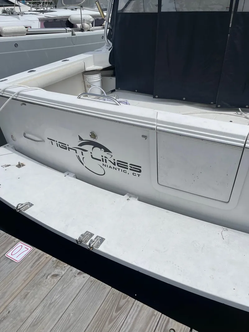 Slide: The Image of 2004 Wellcraft 330 Coastal boat docked, featuring "Tight Lines" logo, Niantic, CT. - 6