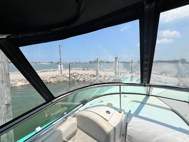 Slide: The Image of View from 2007 Chaparral Signature 280 boat cockpit, overlooking a serene waterfront. - 10