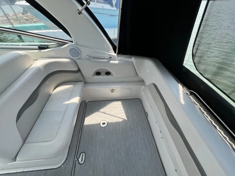 Slide: The Image of Interior seating area of a 2007 Chaparral Signature 280 boat with white and gray upholstery. - 14