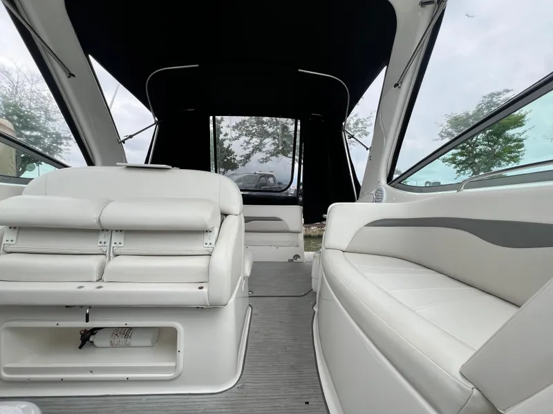 Slide: The Image of 2007 Chaparral Signature 280 boat interior with white seating and black canopy. - 22