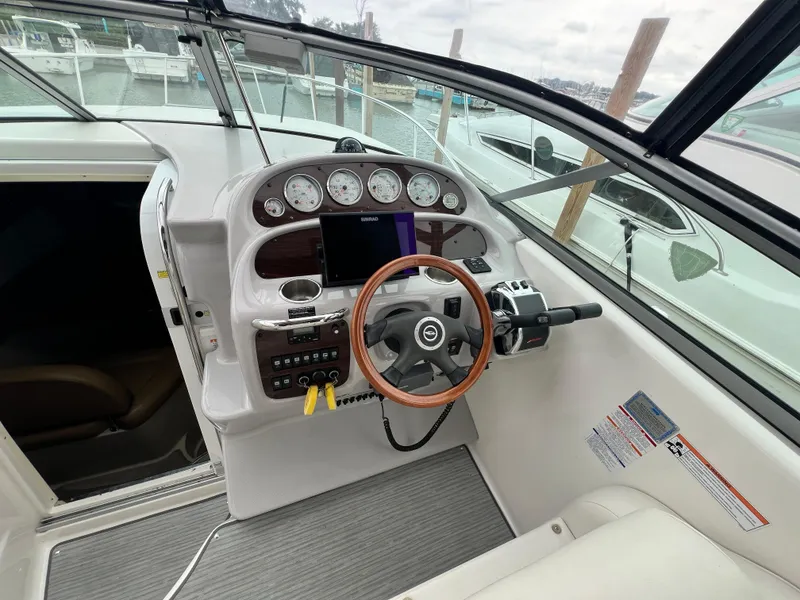 Slide: The Image of 2007 Chaparral Signature 280 boat helm with steering wheel, gauges, and navigation system. - 31