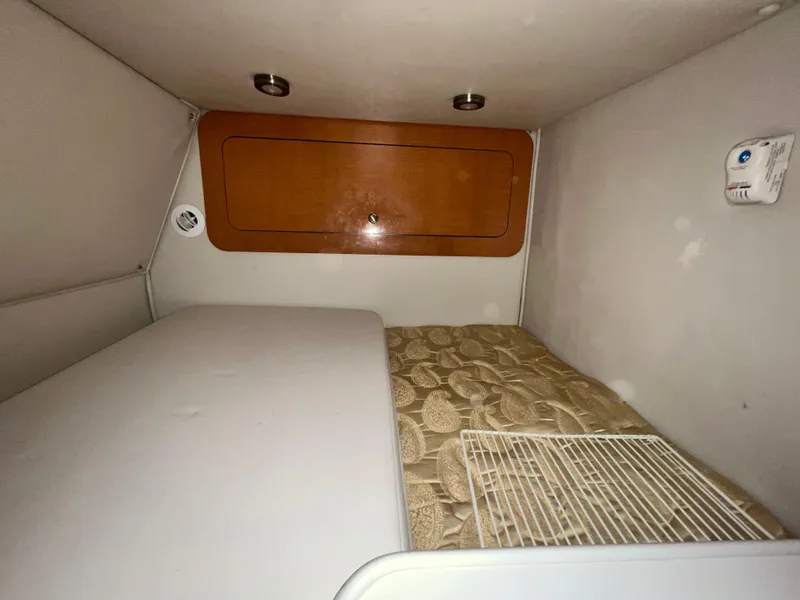Slide: The Image of Interior cabin of 2007 Chaparral Signature 280 boat with bed and storage. - 42