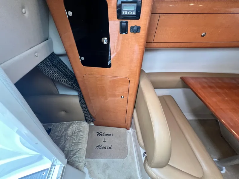 Slide: The Image of Interior of 2007 Chaparral Signature 280 boat with welcome mat and wooden cabinetry. - 43