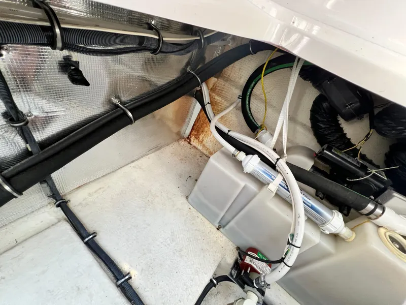 Slide: The Image of Engine compartment of a 2007 Chaparral Signature 280 boat with various hoses and wiring. - 45