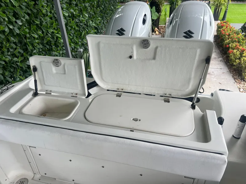 Slide: The Image of Hydra-Sports 2400 CC Vector 2000 boat with open storage compartments and dual Suzuki engines. - 15
