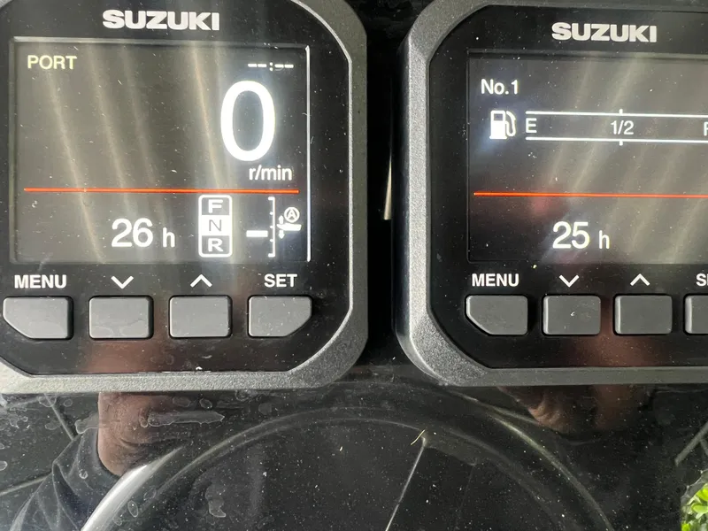 Slide: The Image of Suzuki engine gauges on a 2000 Hydra-Sports 2400 CC Vector boat. - 24