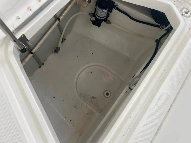 Slide: The Image of Hydra-Sports 2400 CC Vector 2000 boat storage compartment with pump and wiring. - 27
