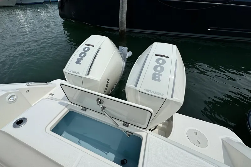 Slide: The Image of 2022 Boston Whaler 330 Outrage with twin Mercury outboard engines on water. - 11