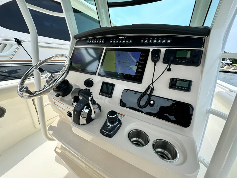 Slide: The Image of 2022 Boston Whaler 330 Outrage helm with advanced navigation and control systems. - 16