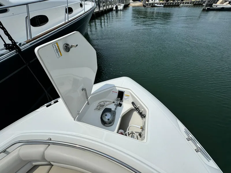 Slide: The Image of 2022 Boston Whaler 330 Outrage bow with open anchor locker at marina. - 20