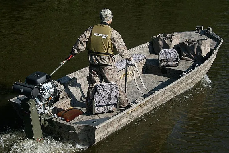 Slide: The Image of 2024 War Eagle 754LDV Sportsman boat on a trailer, parked outdoors on a sunny day. - 16