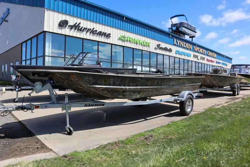 Slide: The Image of 2024 War Eagle 754LDV Sportsman boat with Mercury engine on trailer. - 2