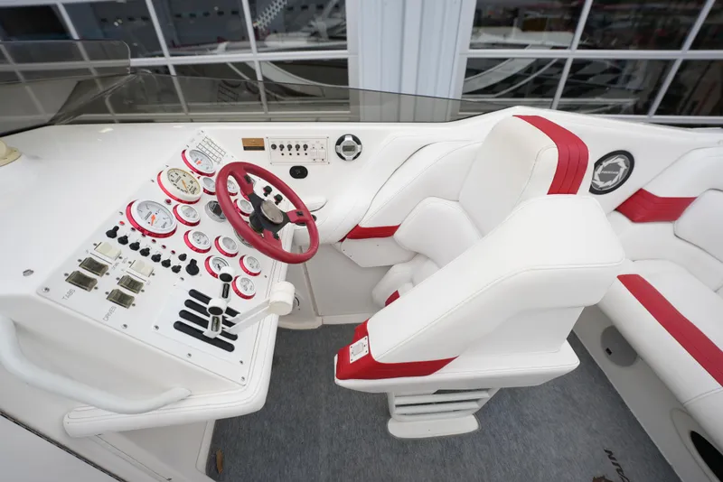 Slide: The Image of 1999 Fountain 35 Lightning boat cockpit with white and red seats and control panel. - 14