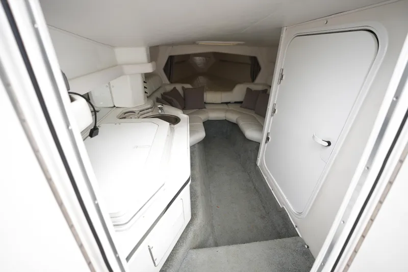 Slide: The Image of Interior cabin of a 1999 Fountain 35 Lightning boat with seating and kitchenette. - 16