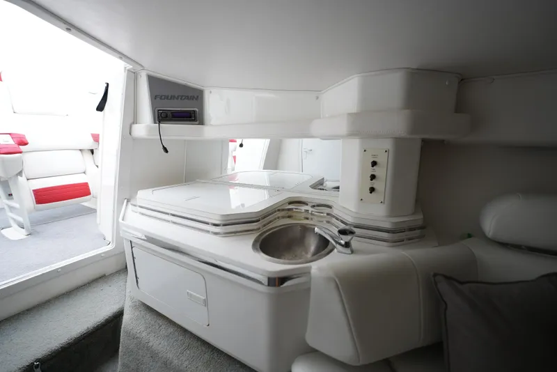 Slide: The Image of Interior of a 1999 Fountain 35 Lightning boat with a compact kitchenette. - 19