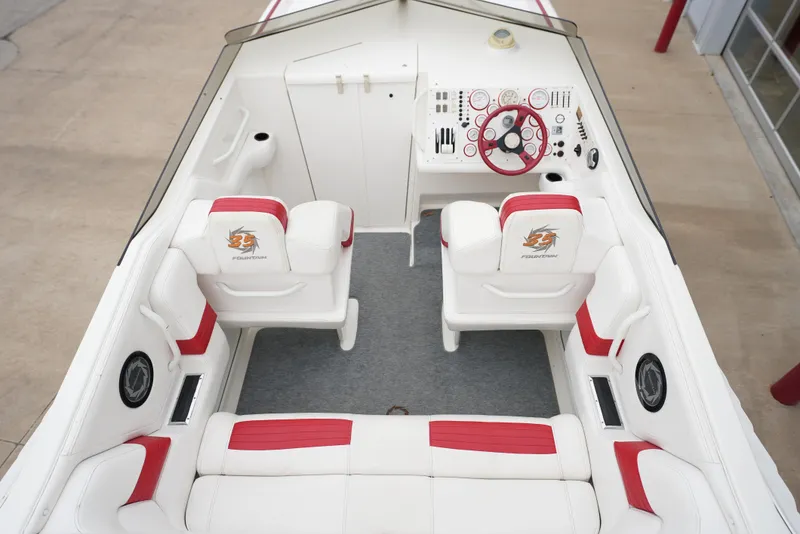 Slide: The Image of 1999 Fountain 35 Lightning boat interior with white and red seating, steering console. - 24