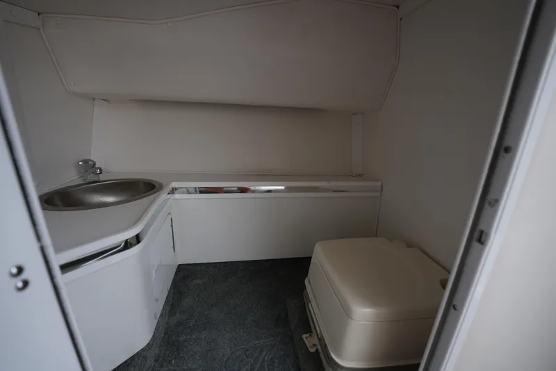 Slide: The Image of 1999 Fountain 35 Lightning boat interior bathroom with sink and portable toilet. - 27