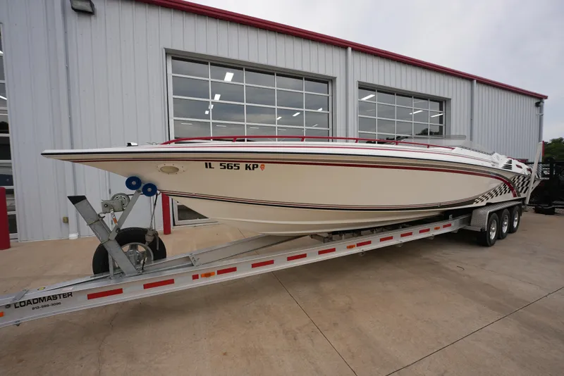 Slide: The Image of 1999 Fountain 35 Lightning speedboat on a trailer outside a garage. - 4