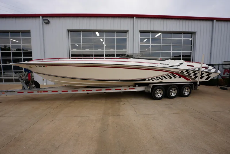 Slide: The Image of 1999 Fountain 35 Lightning speedboat on a trailer outside a garage. - 5