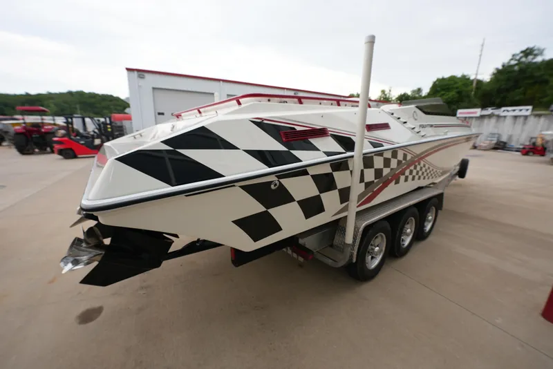 Slide: The Image of 1999 Fountain 35 Lightning speedboat with checkered flag design on trailer. - 6