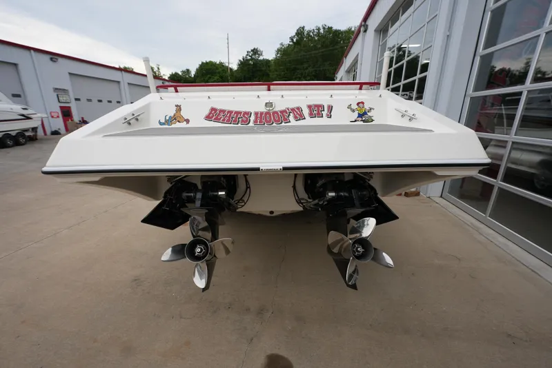 Slide: The Image of 1999 Fountain 35 Lightning boat rear view with dual propellers in a marina. - 7