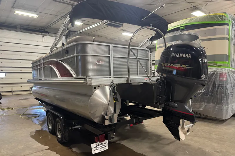 Slide: The Image of 2019 Bennington SX 21 Cruise pontoon boat with Yamaha outboard motor in a garage. - 19