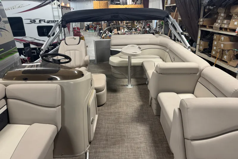 Slide: The Image of 2019 Bennington SX 21 Cruise pontoon boat interior with beige seating and helm. - 25