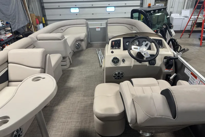 Slide: The Image of 2019 Bennington SX 21 Cruise interior with beige seating and modern helm controls. - 26