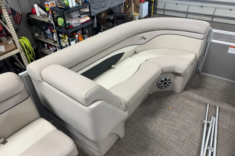 Slide: The Image of 2019 Bennington SX 21 Cruise boat interior with beige seating and speaker. - 27