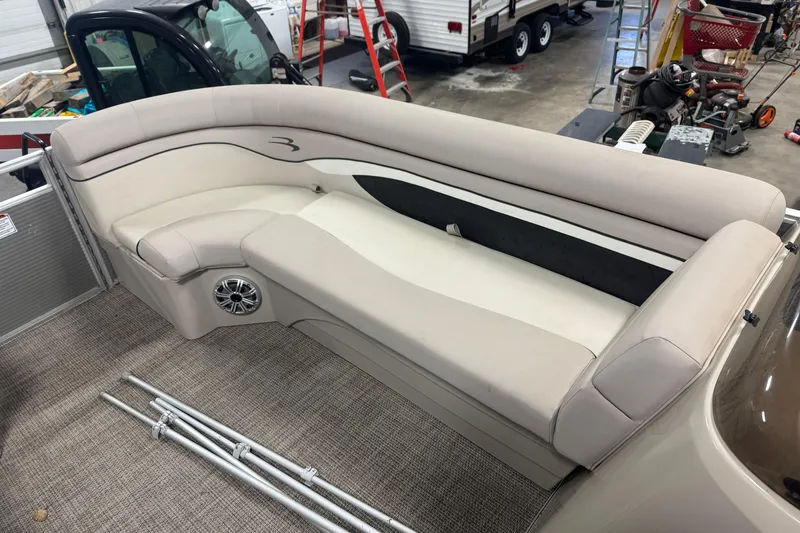 Slide: The Image of 2019 Bennington SX 21 Cruise boat interior with beige seating and speaker. - 28