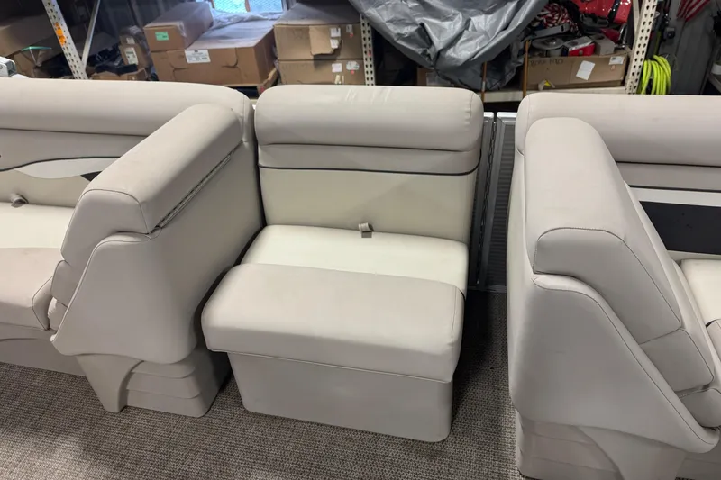 Slide: The Image of 2019 Bennington SX 21 Cruise boat seats in storage, showcasing beige upholstery. - 29