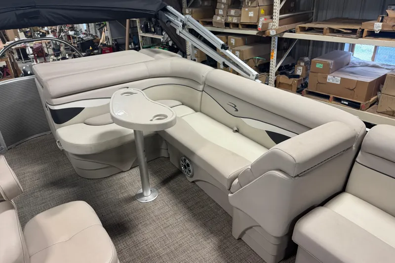 Slide: The Image of 2019 Bennington SX 21 Cruise boat interior with beige seating and a small table. - 30