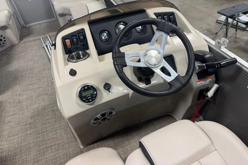 Slide: The Image of 2019 Bennington SX 21 Cruise boat dashboard with steering wheel and controls. - 32