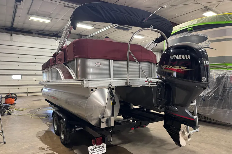 Slide: The Image of 2019 Bennington SX 21 Cruise pontoon boat with Yamaha outboard motor in a garage. - 36