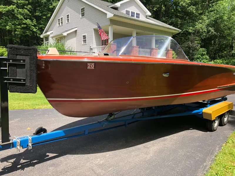 Slide: The Image of 1959 Chris-Craft 18 Continental boat on a trailer in front of a house. - 3